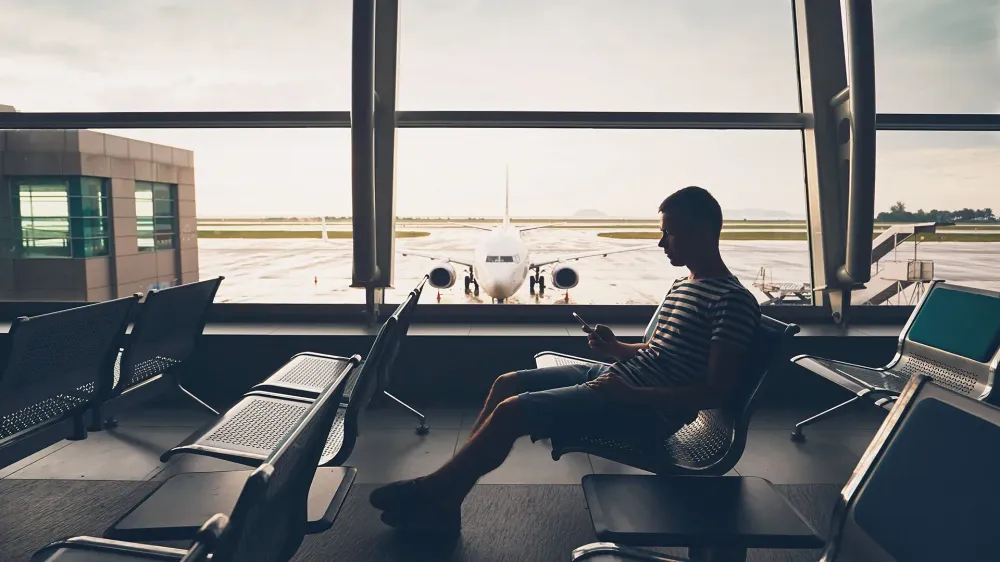 man on his phone at the airport.